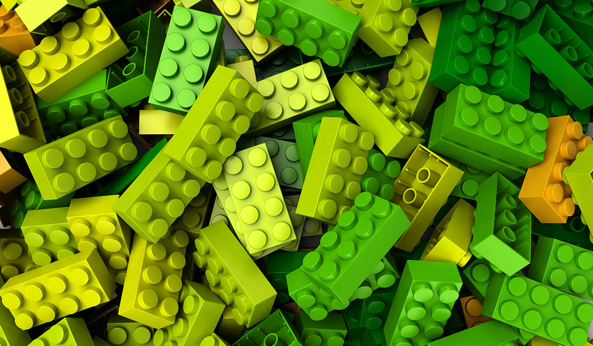 A pile of green and yellow lego bricks. Image credit: Adobe Stock